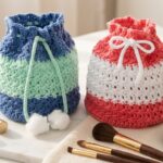 Two-color drawstring crochet makeup bag pattern in denim-mint and coral-white on a modern marble vanity