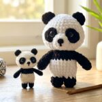 Free panda crochet pattern plushies in large chenille and mini cotton yarn on a sunlit wooden craft desk