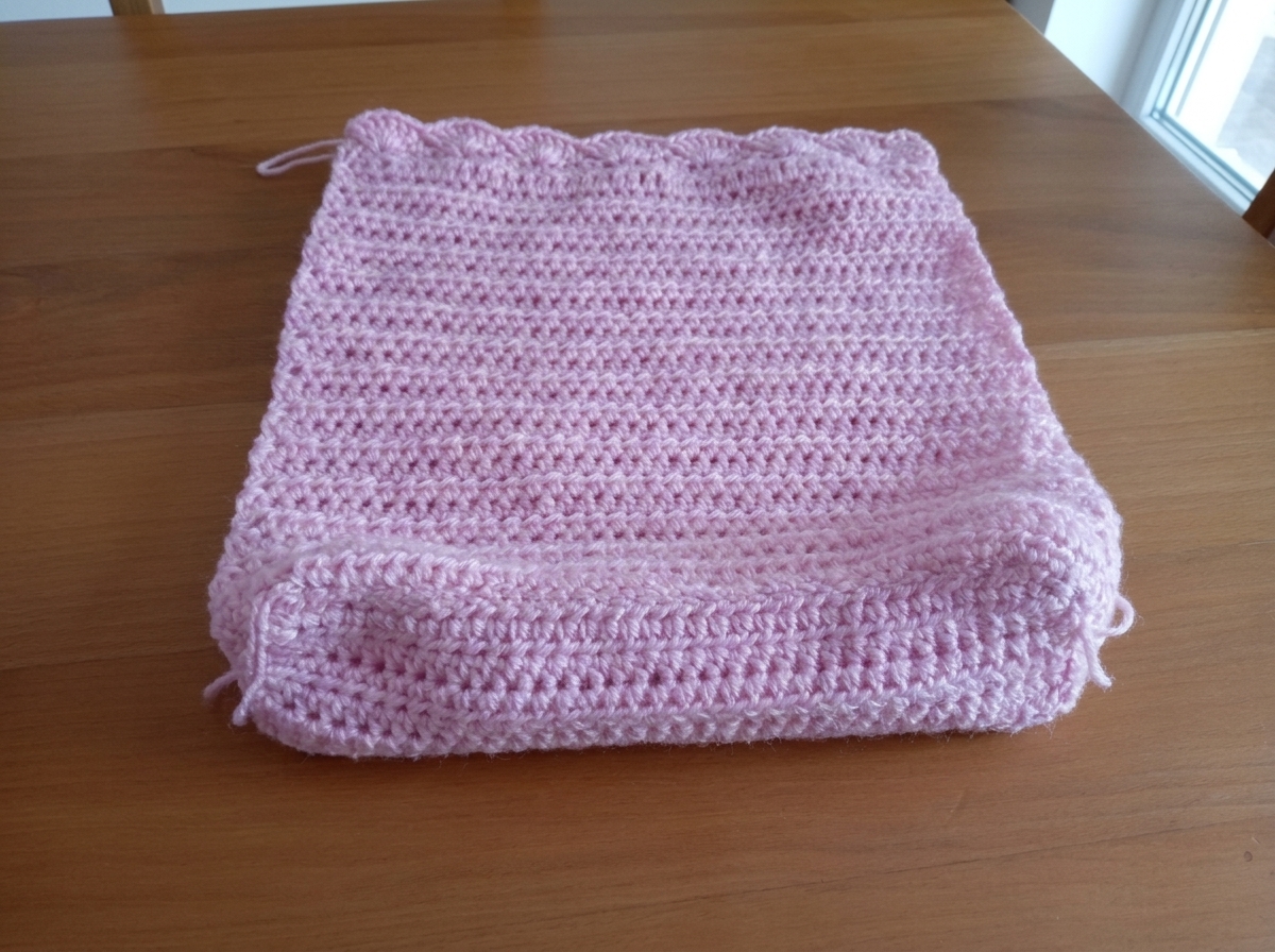 Step 4 of the crochet tote bag pattern showing the flat boxy bottom base completely sewn to the front panel